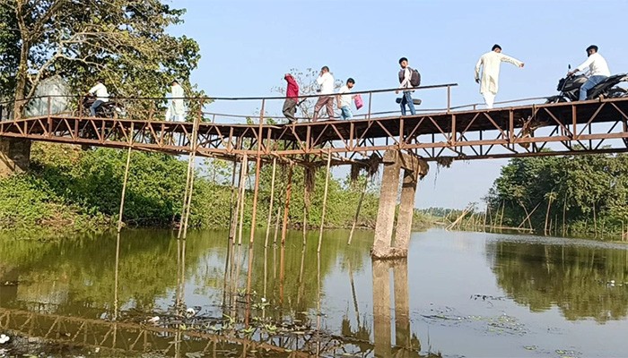 ​ঝুলে পড়া লোহার সেতু বাঁশ দিয়ে ঠেকানোর চেষ্টা